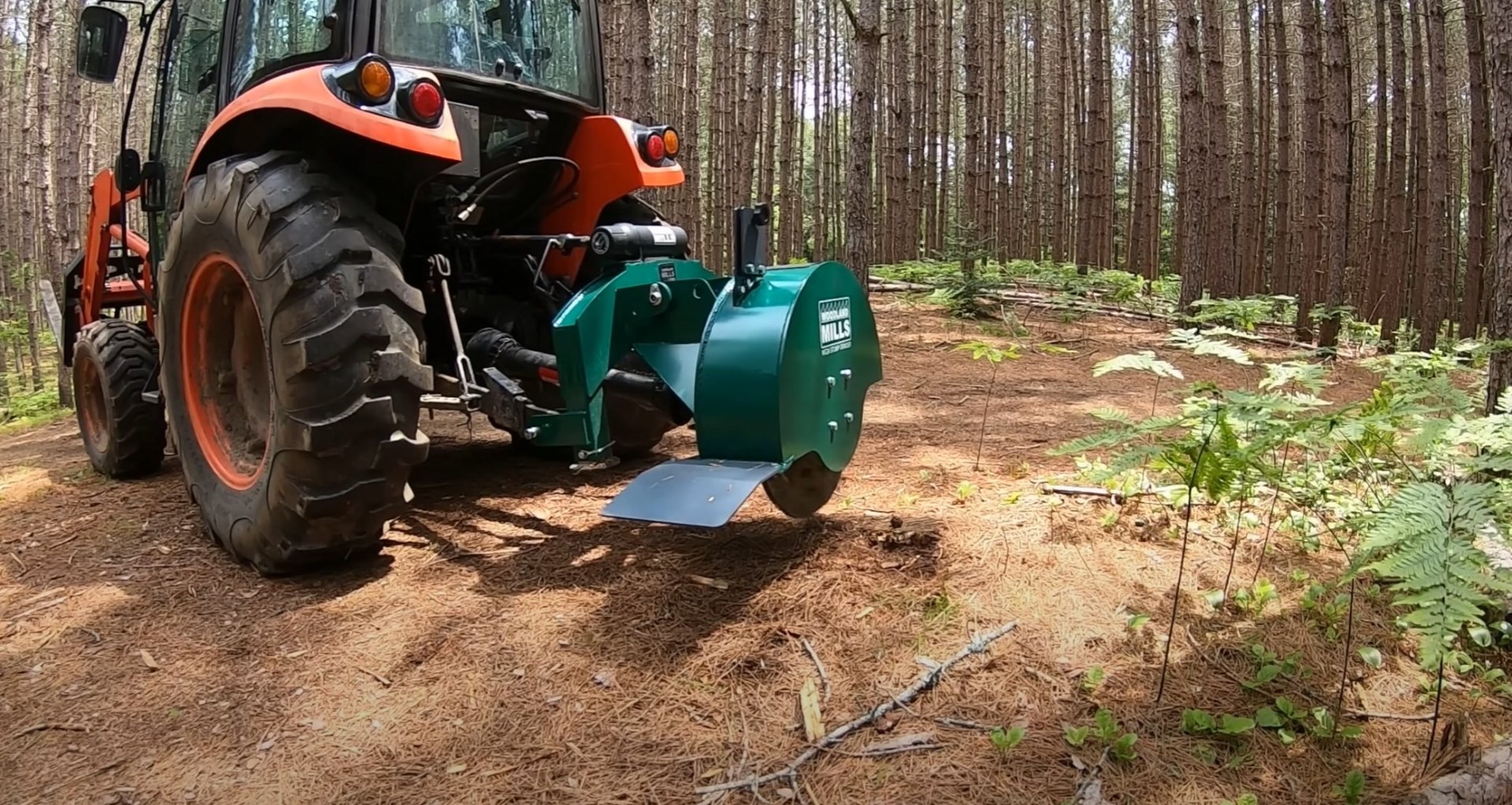 Stump grinding services using specialized tractor-mounted equipment Professional stump grinding equipment in forest setting removing tree stumps